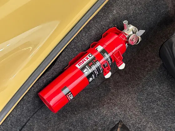 Red MaxOut 2.5 lb extinguisher in the frunk of a classic 1977 Porsche 911S